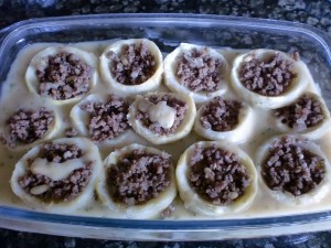 Stuffed Artichoke Hearts with sauce ready for the oven. 